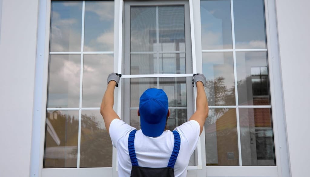 Contractor installing a residential replacement window