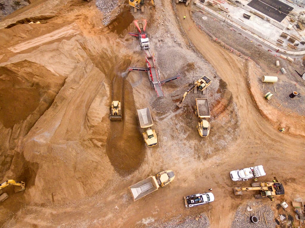Heavy equipment grading and preparing a commercial construction site
